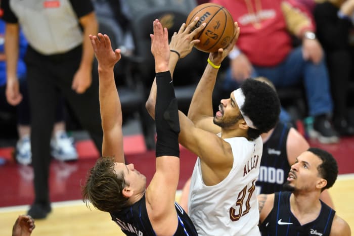 Feb 22, 2024; Cleveland, Ohio, USA; Cleveland Cavaliers center Jarrett Allen (31) shoots beside Orlando Magic center Moritz Wagner (21) in the fourth quarter at Rocket Mortgage FieldHouse. Mandatory Credit: David Richard-USA TODAY Sports